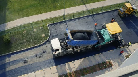 Timelapse. Constructions workers working on road. Asphalt paver applying hot Stock Footage 119376085