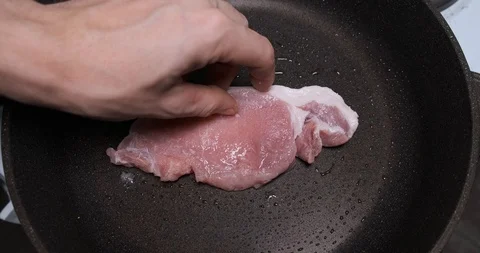 Timelapse of cooking piece of meat in pan, put raw piece of beef on frying pan Stock Footage 120896060