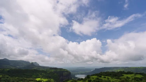 Timelapse - Cotton candy clouds over a valley 4K60 Stock Footage 270320693