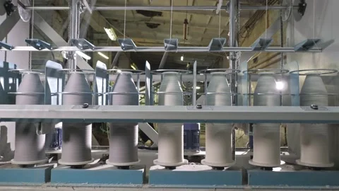 Timelapse of Cotton yarn on bobbin. Spool of thread closeup on clothing factory Video stock 222133357