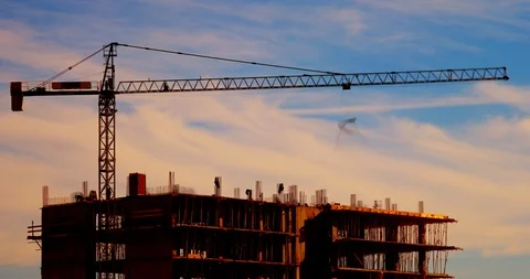 Timelapse of crane and workers building new construction at sunset Stock Footage 105993810