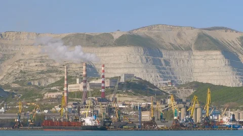 Timelapse on crane at work in an industrial port: cargo ship moored Stock Footage 97944233