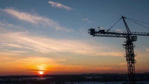Timelapse with crane working on construction site on sunset sky background Stock Footage 72573473