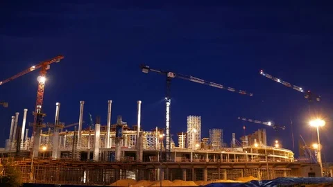 Timelapse with cranes working on construction site on night sky background Stock Footage 71640536