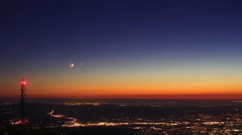 Timelapse of crescent moon setting over radio tower Stock Footage 54967798