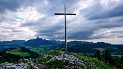 Timelapse of Cross on Rocky Summit with Rolling Hills in Background and Moving Stock Footage 314374000
