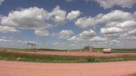 Timelapse cumulus above pumpjack wide Stock Footage 268260042