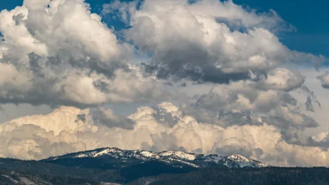 Timelapse of cumulus clouds floating above snow covered mountains Stock Footage 278232924