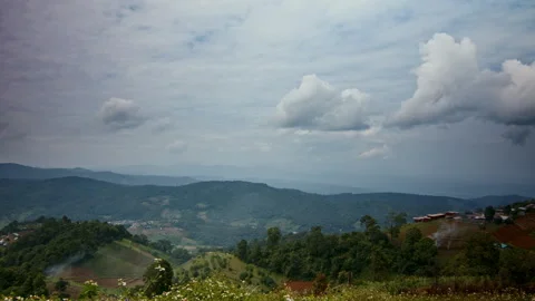 Timelapse of cumulus clouds moving in the blue sky above the hills Stock Footage 261490488