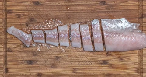 Timelapse of cutting fresh salmon fish fillet at the cutting wooden plate Stock Footage 145916663