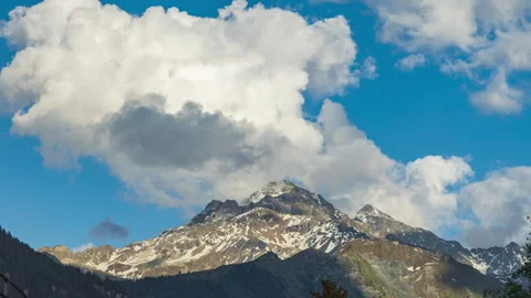 Timelapse of dancing clouds above the mountains. Mountain landscape. Piz d'.. Video stock 244489339