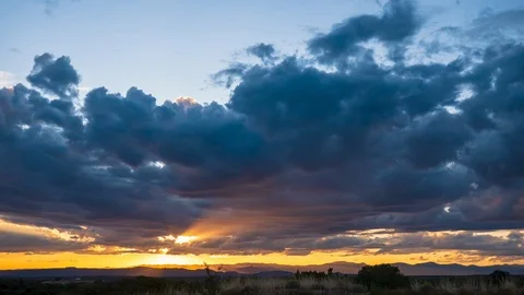 Timelapse of Dark clouds moving over sky at Sunset Stock Footage 116345994