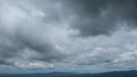 Timelapse of dark clouds moving over the hills Stock Footage 298068912