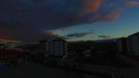 Timelapse dark clouds over a city, clouds over a city at sunset 動画素材 104511335