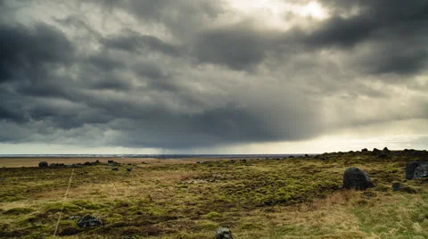 Timelapse of dark clouds over a field Stock Footage 60970524