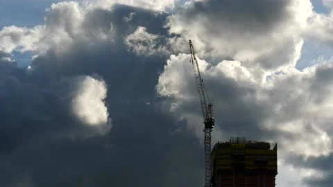 Timelapse of dark clouds rolling over a construction Crane 動画素材 159921752