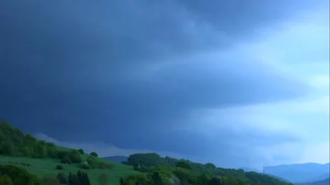 Timelapse dark storm clouds cover the landscape almost into the darkness Stock Footage 134172655
