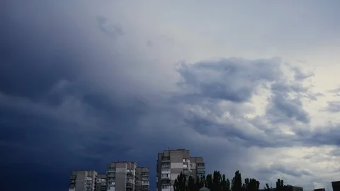 Timelapse of dark storm clouds over a small town at sunset Stock Footage 110751909