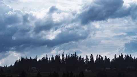 Timelapse of dark storm clouds with rain rolling over pine tree forest Stock Footage 153903365