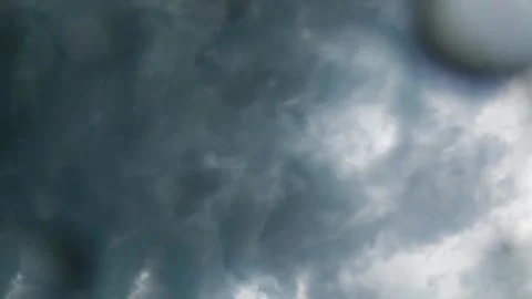 Timelapse of dark swirling storm clouds roiling in sky with rain drops 스톡 동영상 336422384