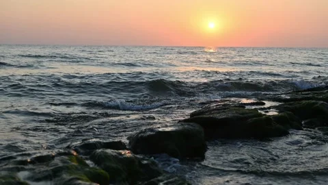 Timelapse: The dawn is reflected on the wet sand of the beach with stones Stock Footage 161406692