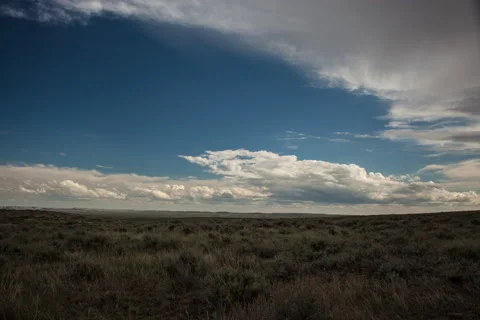 Timelapse of daytime clouds over wide expanse of prairie Stock Footage 62057077