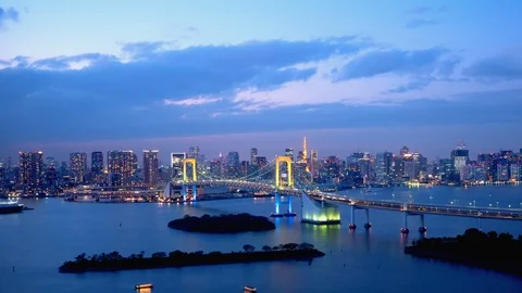 TimeLapse - Daytime to night scenery in Tokyo and Tokyo bay - Pan right to left Stock Footage 99716505