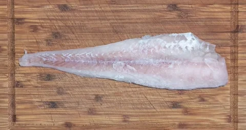 Timelapse of defreezing fresh salmon fish fillet at the cutting wooden plate Stock Footage 145916652