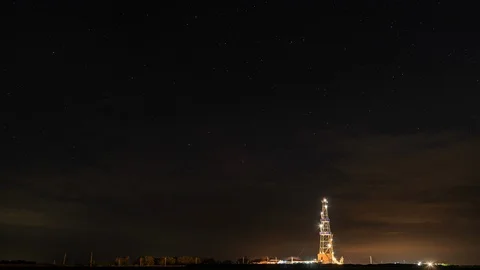 Timelapse the derrick against of background of the star night sky. Stock Footage