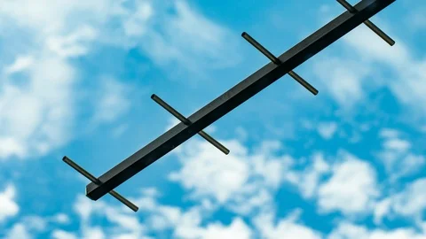 Timelapse of Digital TV (UHF) antenna against cloudy deep blue sky Stock Footage 109059477