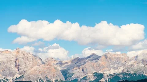 Timelapse Dolomites mountain range Italy jagged peaks moving clouds blue sk.. Stock Footage 336229193