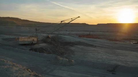 Timelapse. Dragline excavator load ore into dump-track. Sunset. Stock Footage 63586131
