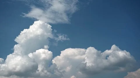 Timelapse of dramatic building cumulus storm clouds in a bright blue sky Stock Footage 310690756