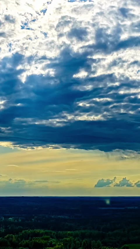 Timelapse of Dramatic Clouds and Sunlight Over Forest Landscape at Sunset Stock Footage 340565809