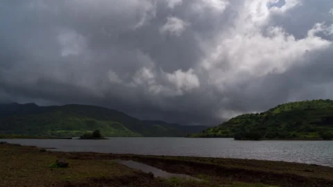 Timelapse - Dramatic clouds moving over a lake 4K30 Stock Footage 268973004