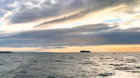Timelapse of dramatic clouds over a sea and an oli container ship Video stock 162902529