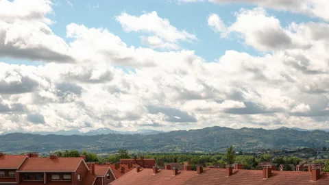 Timelapse of dramatic clouds over a village in the countryside. Stock Footage 159094747