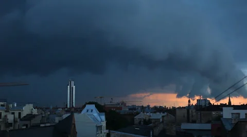 A timelapse of a dramatic cyclone clouds mass passing over a city at sunset Stock-Footage 41338305