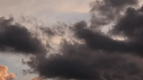 Timelapse of Dramatic Dark Clouds Moving Across Colorful Sunset Sky Stock Footage 339333819