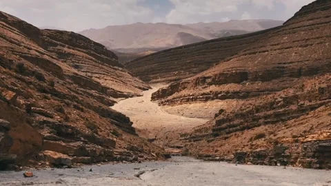 Timelapse of a dramatic desert canyon with a winding dry riverbed Stock Footage 345576461