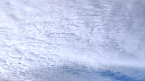 Timelapse of dramatic evening clouds moving across blue sky during rainy season 動画素材 338315256