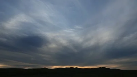 Timelapse of dramatic gray clouds floating through a sky with thin overcast Stock Footage 340240205