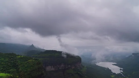 Timelapse - Dramatic monsoon clouds over mountains and lake 4K60 Stock Footage 270321082