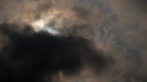 Timelapse of dramatic movement of dark clouds covering the sun #1 Stock Footage 290504750