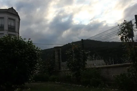 Timelapse of dramatic moving clouds over a mountain landscape at twilight Stock-Footage 347253934