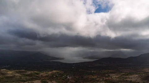 Timelapse - Dramatic rainy clouds moving over a lake 4K60 Stock Footage 270083990
