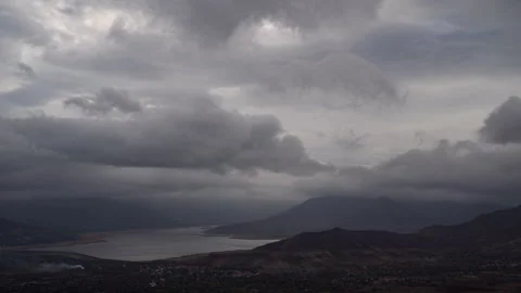Timelapse - Dramatic rainy clouds moving over a lake 4K60 Stock Footage 270084198