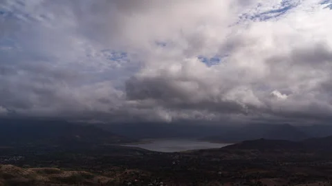 Timelapse - Dramatic rainy clouds moving over a lake 4K60 Stock Footage 270084312