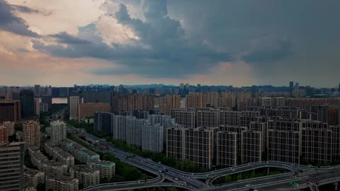 Timelapse of dramatic storm clouds rolling over Hangzhou cityscape at dusk Video stock 314114292
