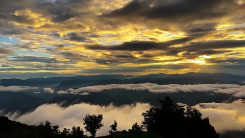Timelapse of Dramatic Sunrise with Golden Clouds Over Remote Chinese Mountains Stock Footage 337860063